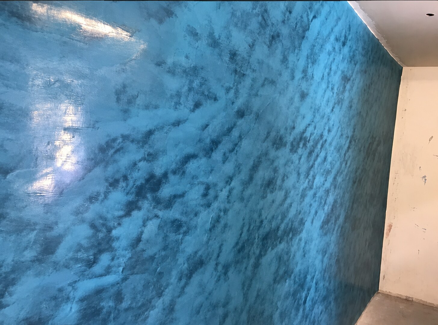 Close view of a blue polished decorative plaster wall